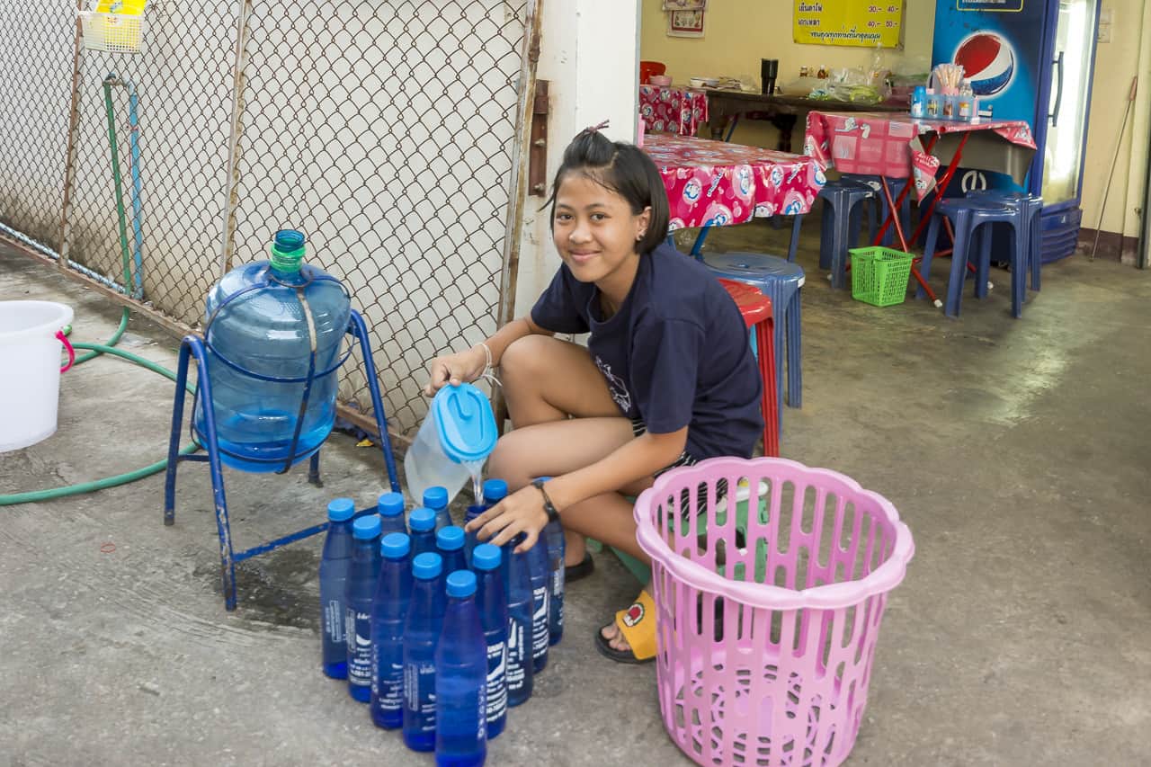 Mädchen beim Abfüllen von Wasser als kleiner zuverdienst
