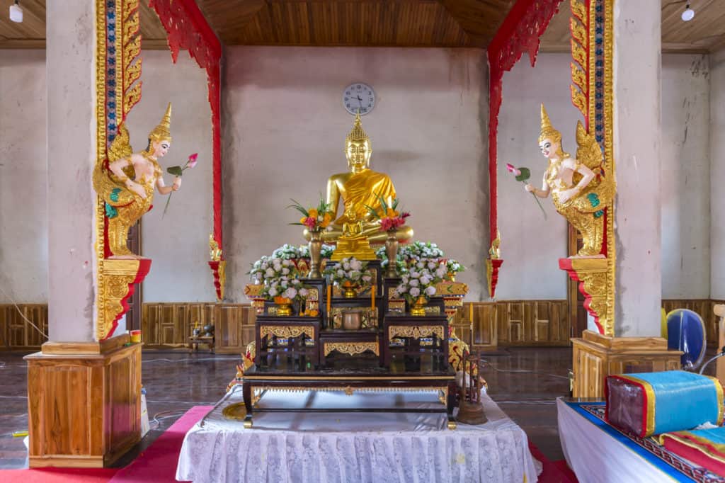 Zwei Figuren übergeben Buddha Lotusknospen